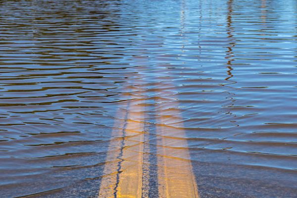 Closeup of high water flooding on neighborhood street.