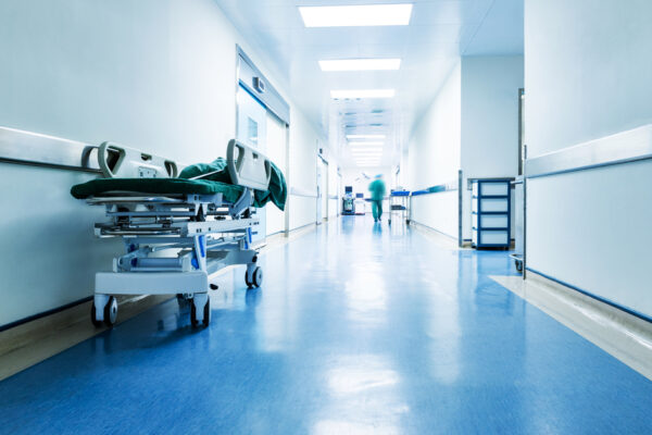 Doctors,Or,Nurses,Walking,In,Hospital,Hallway,,Blurred,Motion.