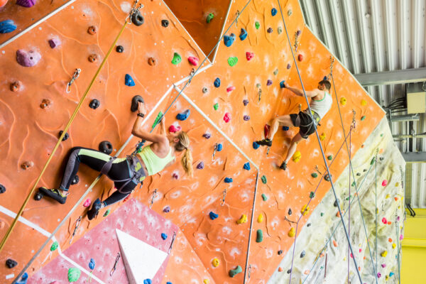 Fit,Couple,Rock,Climbing,Indoors,At,The,Gym